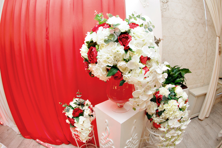 Wedding decoration with the red flowers and candlesの写真素材