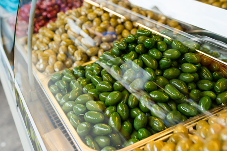 Eco-friendly products on a market stall . Different varieties of pickled olivesの写真素材