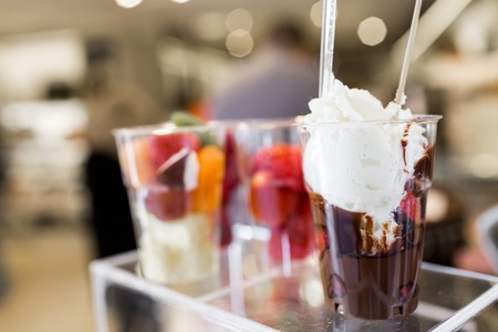 Fruit salad arranged in plastic cups for sale. refrigerator showcase or buffet. Used in cocktails and as a topping to the chocolate fountain. Selective focusの写真素材