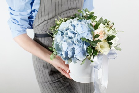 beautiful bouquet made of different flowers in young girl hand . colorful color mix flower. Work...