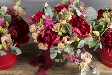 Bridal bouquet and boutonniere. Red and peach color flowersの写真素材