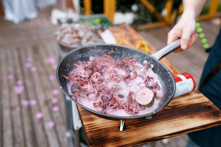 Flambe. Fried seafood and octopus on iron pan.の写真素材