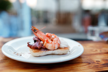 Fried big shrimp on White bread ciabatta toasted on an outdoor grillの写真素材