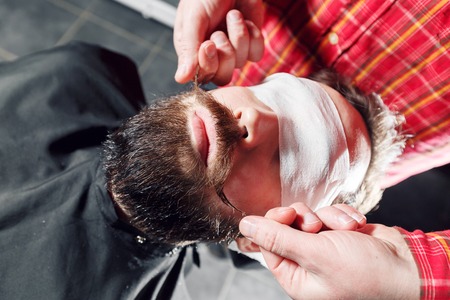 Hipster guy getting his mustache ready for twistの写真素材