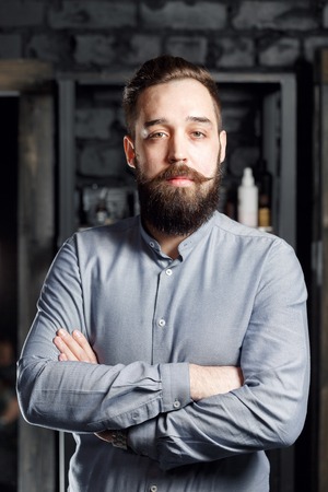 Portrait of bearded male in gray shirtの写真素材