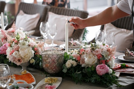 Wedding Day. the waiter lights a candle. romantic dinnerの写真素材