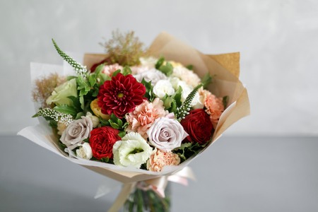 beautiful bouquet made of different flowers on grey background. colorful color mix flower. copy spaceの写真素材