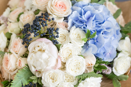 Rich bunch of peonies, roses and blue hydrangea flowers, green leaf. Fresh spring bouquet. Summer Background. Selective focus.の写真素材