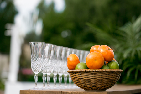 Detail of a table dish with glasses at an event on a sunny summer dayの写真素材