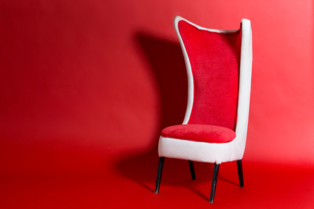 modern red chair on a red background. copy spaceの写真素材