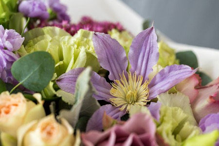 Close-up floral composition with roses and mix flowers on a light background.の写真素材
