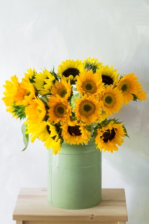 Bouquet of sunflowers and wild flowers on wooden table, copy spaceの写真素材