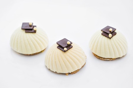 Three cream cupcake background on whiteの写真素材