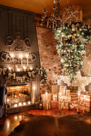alternative tree upside down on the ceiling. Winter home decor. Christmas in loft interior against brick wall.の写真素材
