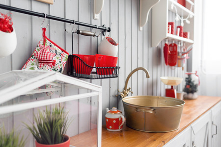 shelves with dishes. Interior light grey kitchen and red christmas decor. Preparing lunch at home on the kitchen concept.の写真素材