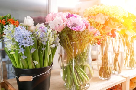 different varieties. Fresh spring flowers in refrigerator for flowers in flower shop. Bouquets on shelf, florist business.の写真素材