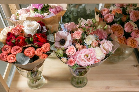 different varieties. Fresh spring flowers in refrigerator for flowers in flower shop. Bouquets on shelf, florist business.の写真素材