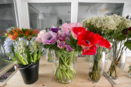 different varieties. Fresh spring flowers in refrigerator for flowers in flower shop. Bouquets on shelf, florist business.の写真素材