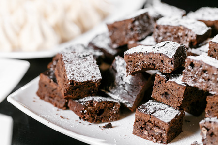 Chocolate brownies closeup on a black tableの写真素材