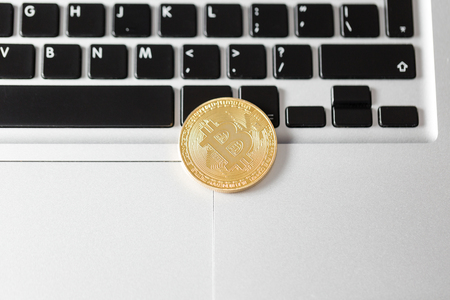 coin bitcoin on the laptop keyboard. the concept of trading cryptocurrency. The rapid growth of the currency.の写真素材