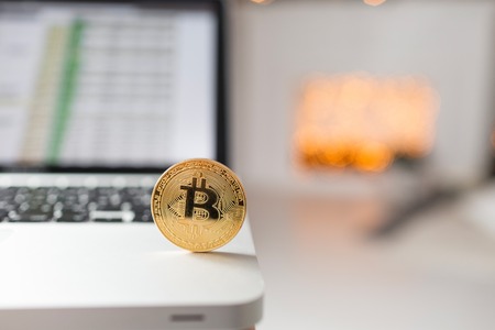 coin bitcoin on the laptop keyboard. the concept of trading cryptocurrency. The rapid growth of the currency.の写真素材