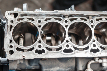 Disassemble engine block vehicle. Motor capital repair. Sixteen valve and four cylinder. Car service concept. The job of a mechanic. Old and new pistons. Top view.の写真素材