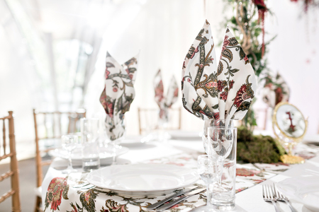 Interior of a wedding tent decoration ready for guests. Served round banquet table outdoor in...