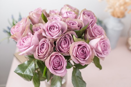 Lilac garden rose. Bouquet flowers of roses in glass vase. Shabby chic home decor. Morning dew