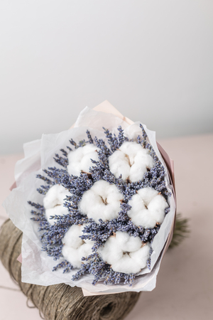 beautiful bouquet lavender and cotton, on table . dried flowers white and lilac colorの写真素材