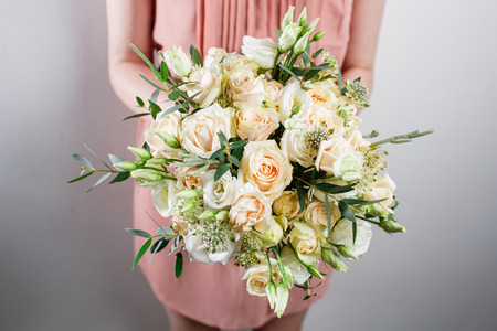 beautiful luxury bouquet of mixed flowers in woman hand. the work of the florist at a flower shopの写真素材