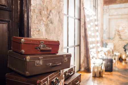 The door and the bag. Vintage used travel suitcases. Many old vintage suitcase. Luggage conceptの写真素材