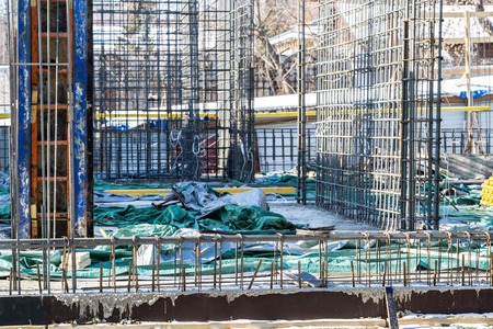 Construction workers fabricating steel reinforcement bar at the construction site.The reinforcement...