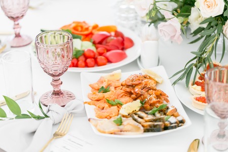 Fish platter. Plate with seafood on the table, snacks at the banquet, wedding banquet, table setting, dinner food, gala dinner.の写真素材