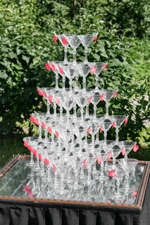 Champagne glass pyramid on wedding party. Tower of glasses of wineの写真素材