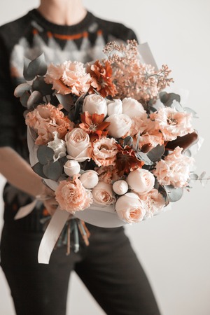 beautiful luxury bouquet of mixed flowers in woman hand. the work of the florist at a flower shop. A small family businessの写真素材