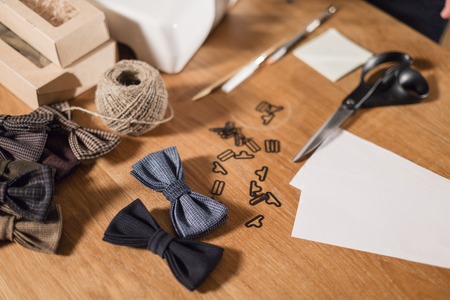 Close-up lots of ready made butterfly bow ties made of wool in the foreground, adds a finished product.の写真素材