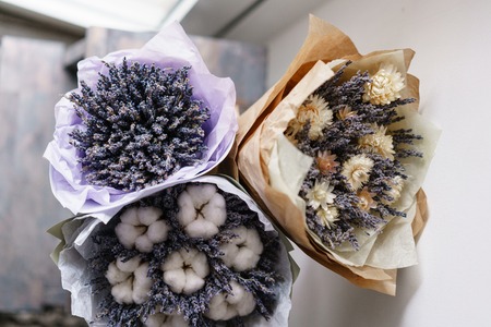 three beautiful and different bouquets lavender on table . dried flowers lilac color. placed in a paper bagの写真素材