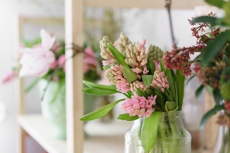 Flower shop concept. Different varieties fresh spring flowers in refrigerator room for flowers....