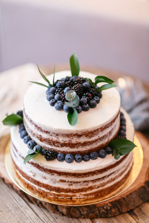 Wedding or birthday cake with berries. Sweet pie on banquet in restaurant.の写真素材