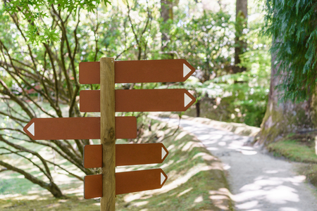 Wooden track pointer in the forests. Pointer on a path in the forest. Sao Miguel, Azores. Portugal.の写真素材