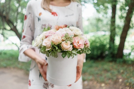 Beautiful summer bouquet. Arrangement with mix flowers. Young girl holding a flower arrangement with peony. The concept of a flower shop. Content for the catalogの写真素材