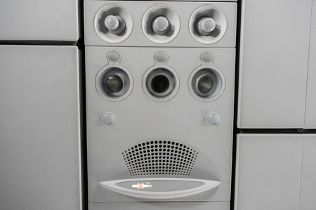 Air condition unit and lighting of aerospace on the ceiling of passenger cabin. Modern Airplane seats in perspective. Transportation concept. Aircraft long-distance international flightの写真素材