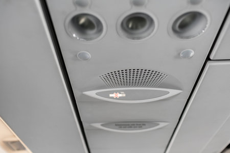 Air condition unit and lighting of aerospace on the ceiling of passenger cabin. Modern Airplane seats in perspective. Transportation concept. Aircraft long-distance international flightの写真素材