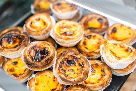 Rows of egg tart, traditional portuguese dessert, pasteis de nata, custard tarts. Cafe on the streets of Lisbon, Portugalの写真素材