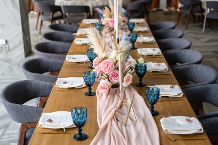 Beautiful and exquisite decoration of the wedding celebration. Banquet served table with a beige...
