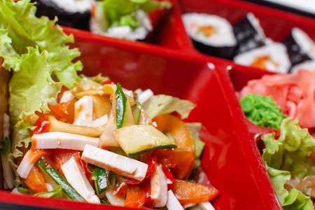 Vegetable salad. Fresh food portion in japanese bento box with salad, main course. Sushi roll with vegetables. Vegetarian dish.の写真素材