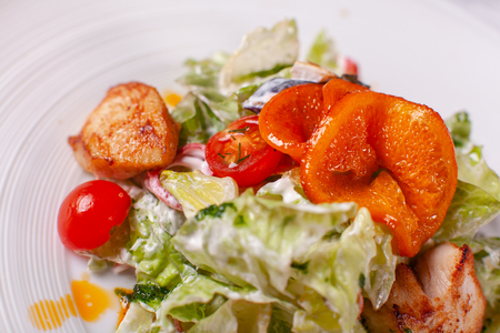 Bowl of salad with duck, orange and vegetables. Asian food. Salad on a white dish on table. restaurant menuの写真素材