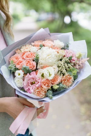 beautiful spring bouquet. flower arrangement with peonies.. The concept of a flower shop, a small family businessの写真素材