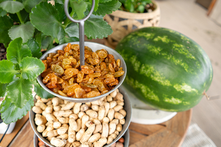 Healthy snack food on wooden table as fruit, raisin, nuts. Fresh watermelon