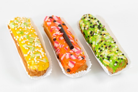 Sweet and colorful eclairs. Group of french dessert Eclair on white background. custard pastry...